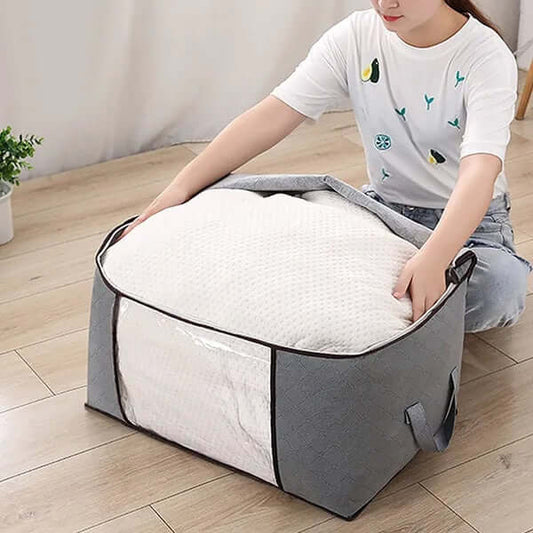 large capacity clothes storage bags being used to store a fluffy comforter, showcasing organizational efficiency.